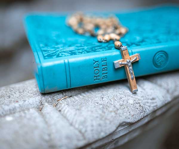 a blue bible with a cross
