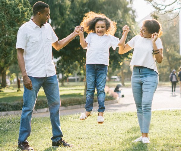 family wearing white shirts and blue jeans in the park